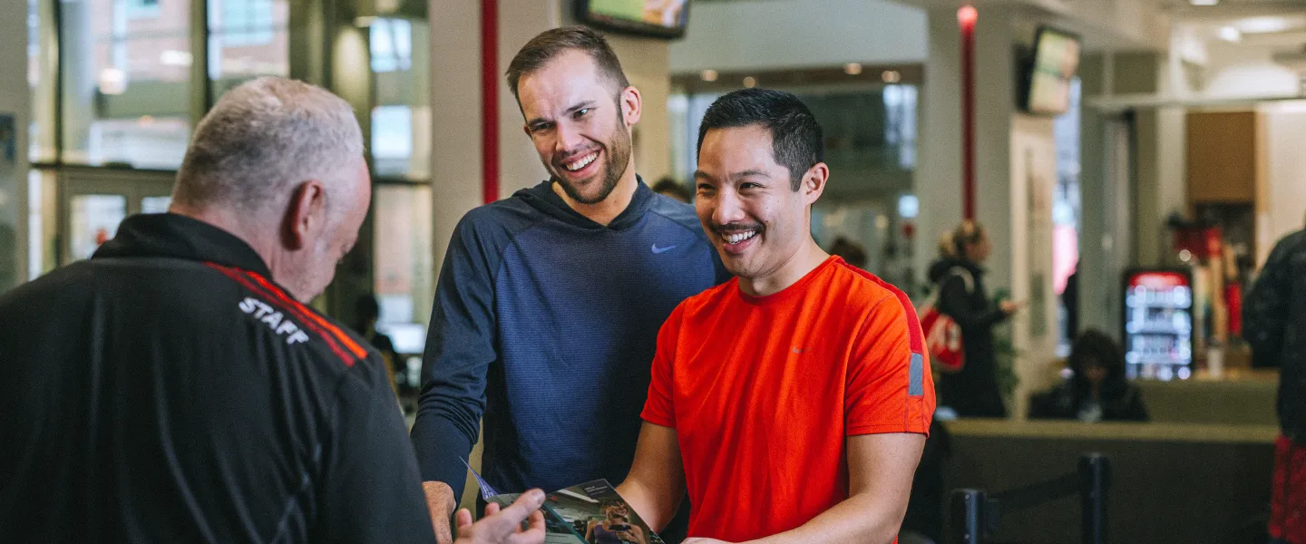 Staff helping YMCA members at the front desk