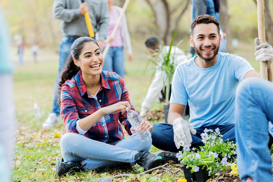 Man and Women helping plant a community garden