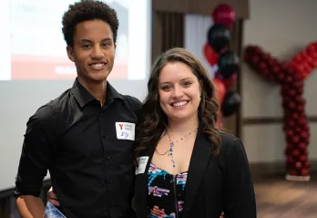 Two young staff members attend the YMCA's Annual Community Gathering.