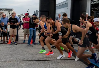 A group of men in colourful shoes get into starting position for Jordan's Run.