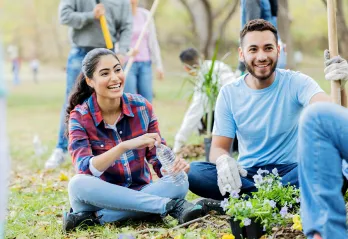 Man and Women helping plant a community garden