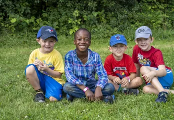 Boys sitting on the lawn during Summer Camp