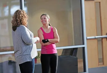 Two Y members chat in a branch common area.