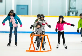 A newcomer family learns to skate in an arena.