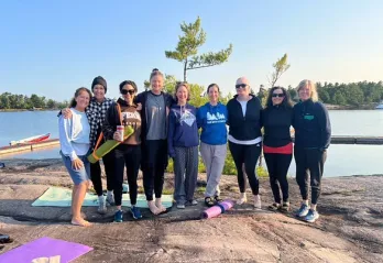 Women on rock after Yoga