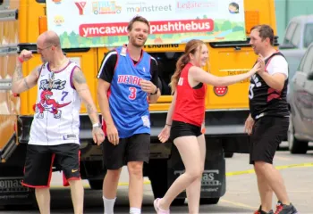 Team high fives in front of bus