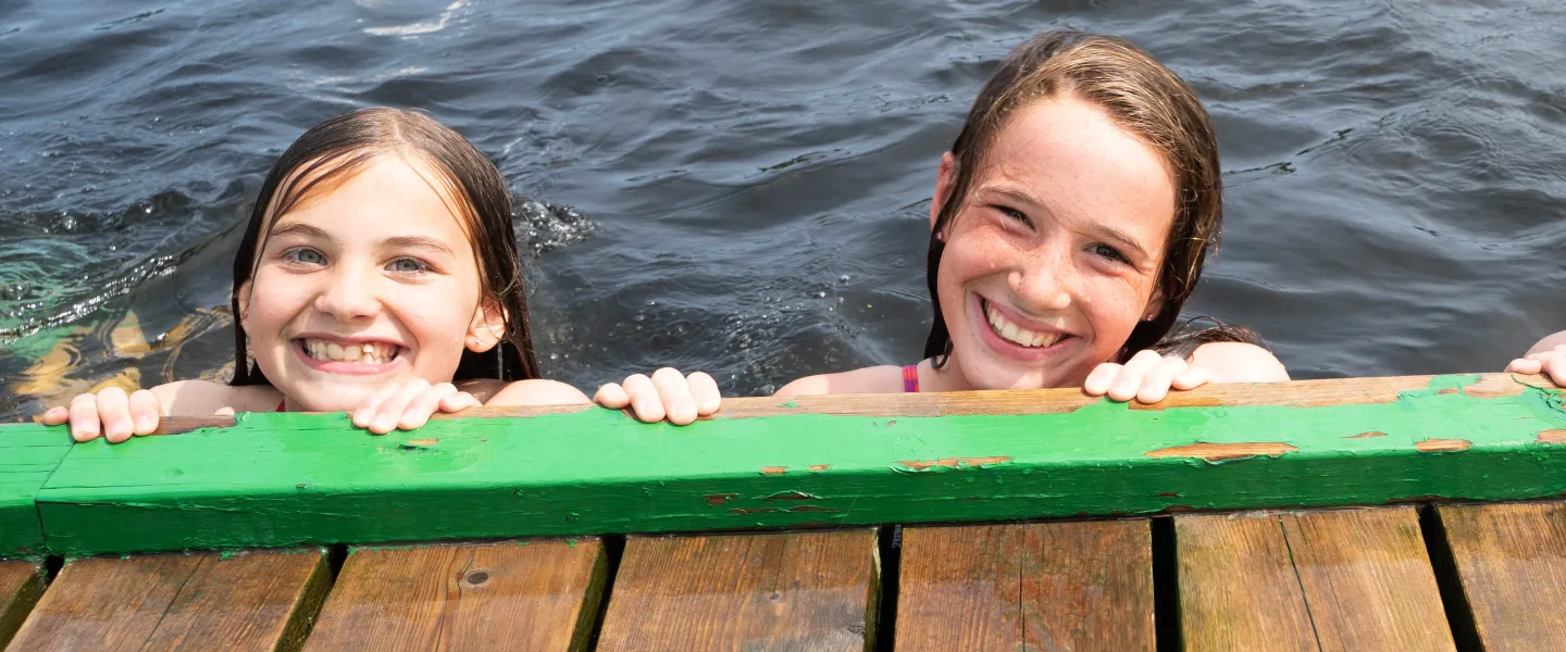Girls swimming off the rocky shores of Beausoleil Island in Georgian Bay Islands National Park, YMCA Camp Queen Elizabeth