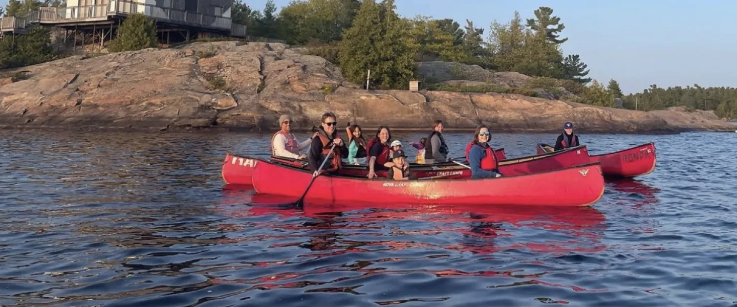 Campers in a canoe on the water