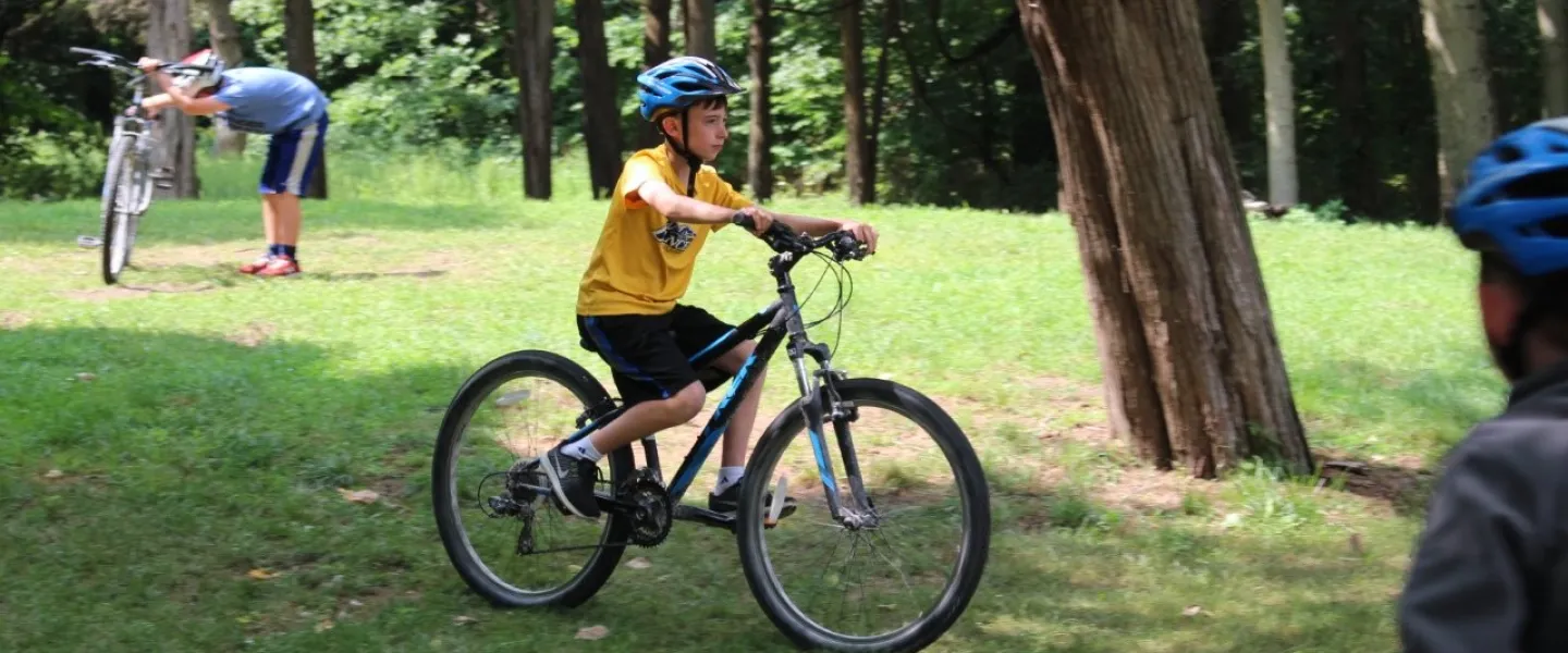 kid on bike at Camp Henry
