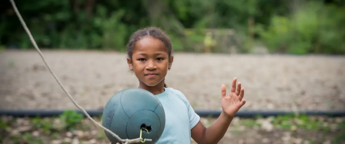 girl playing ball at Camp Henry