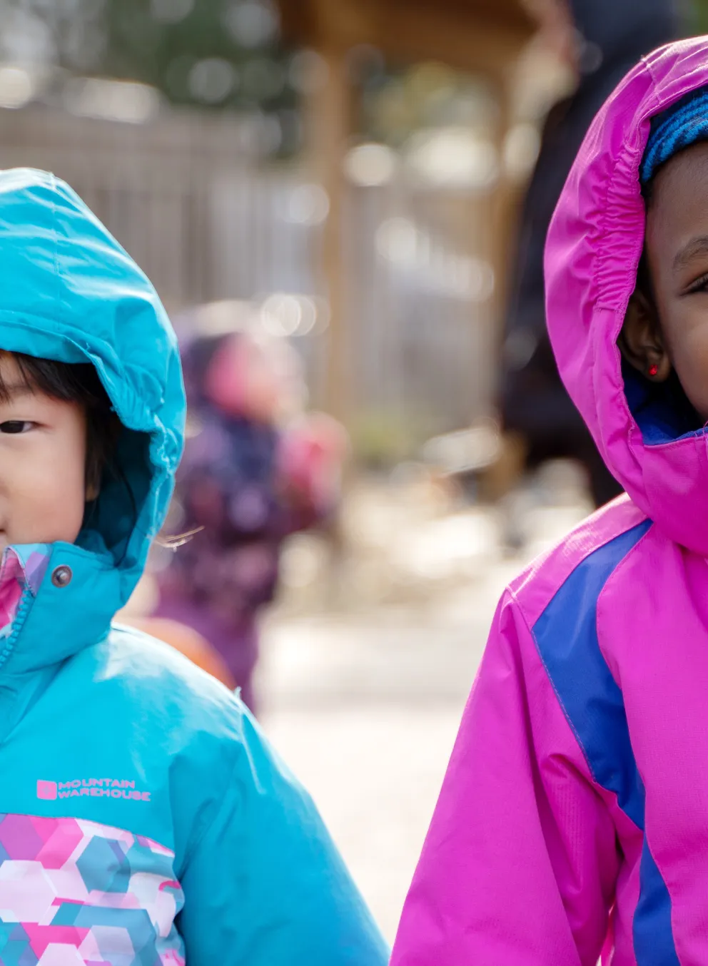Two smiling girls playing outside