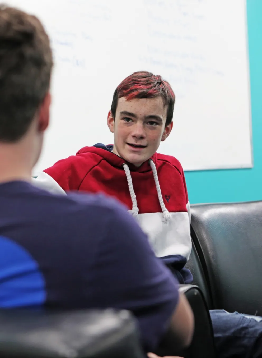 Youth sitting with adult
