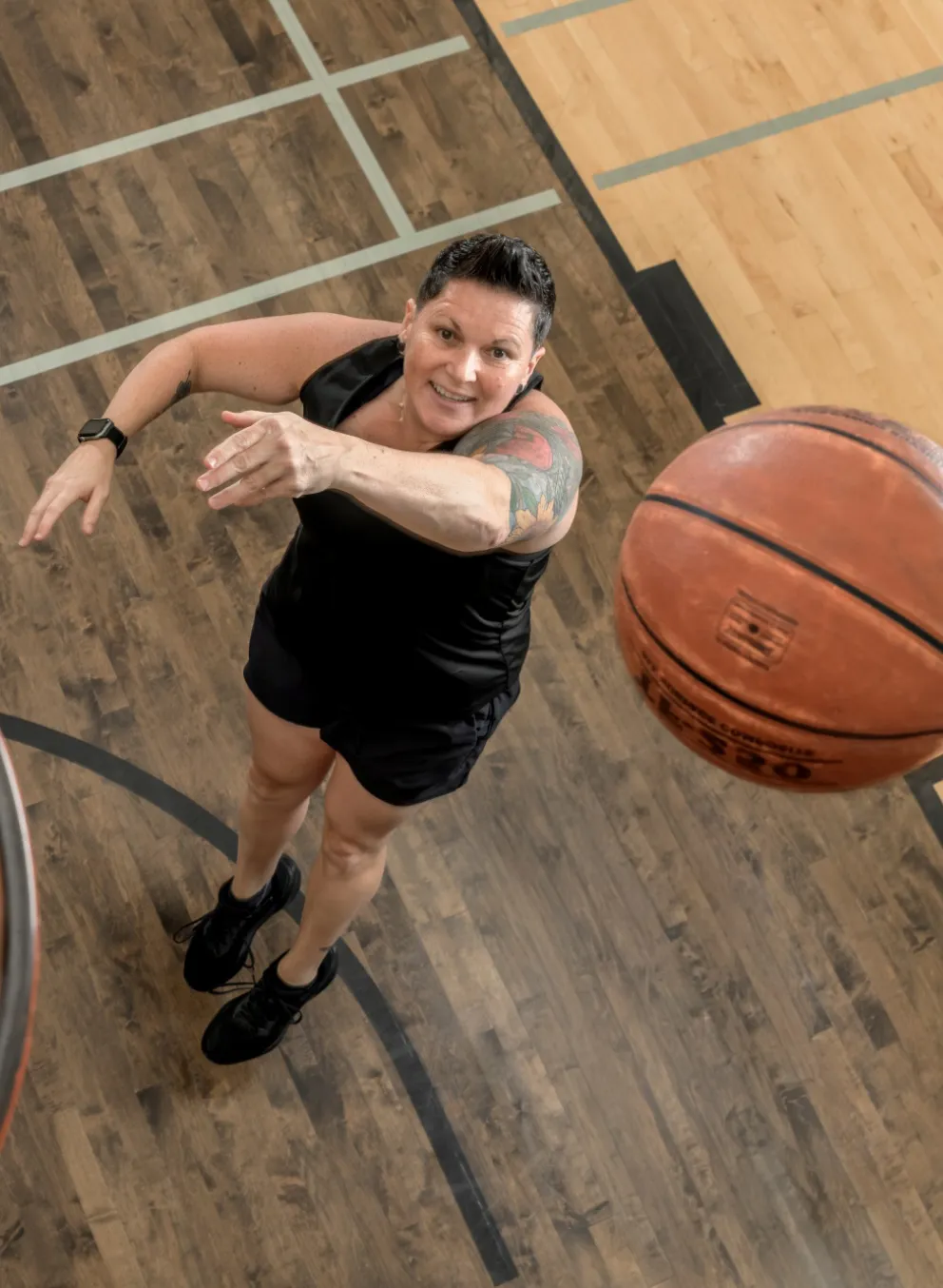 Person shooting a basketball in the hoop