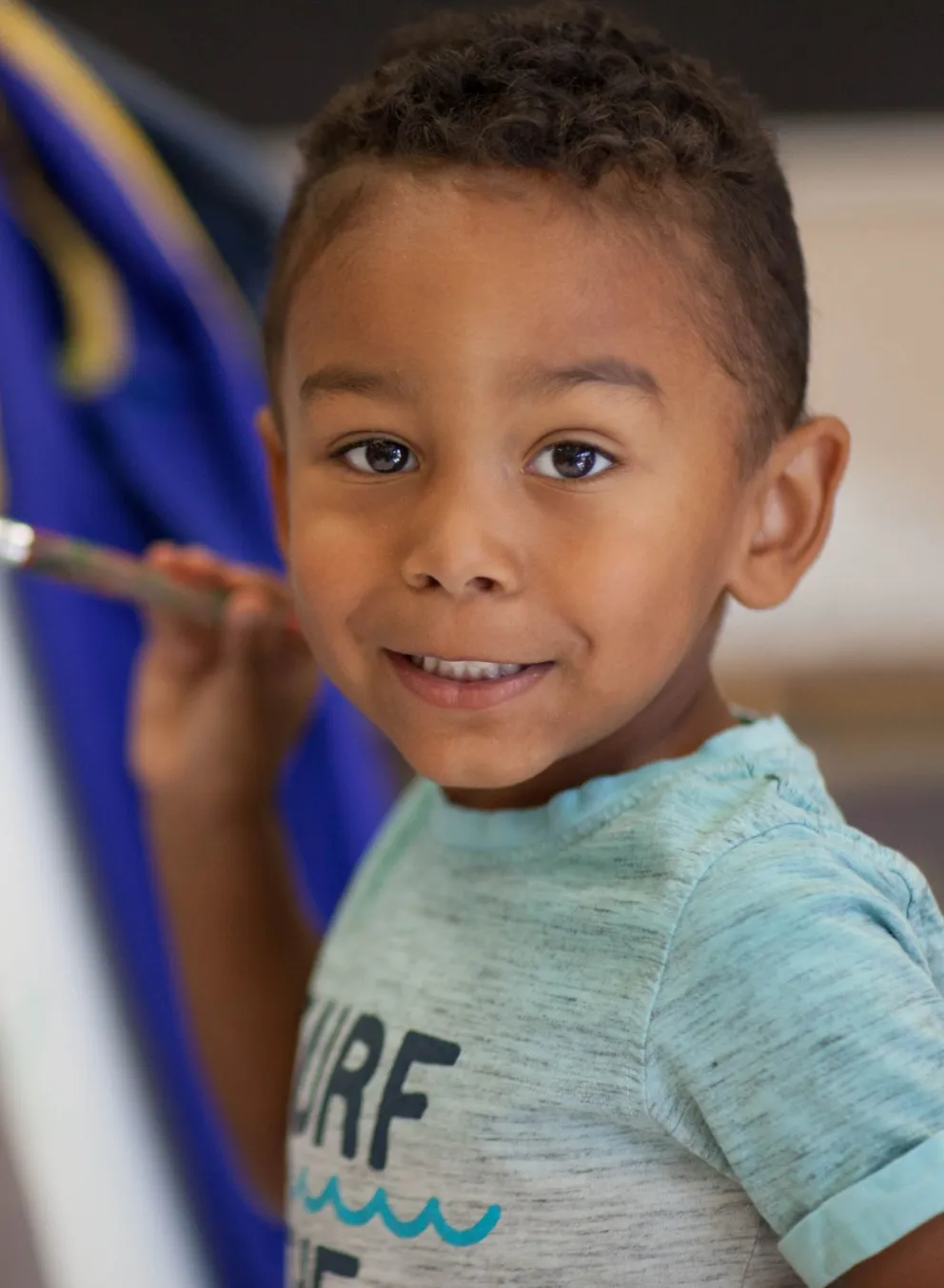 Boy painting at a YMCA Child Care
