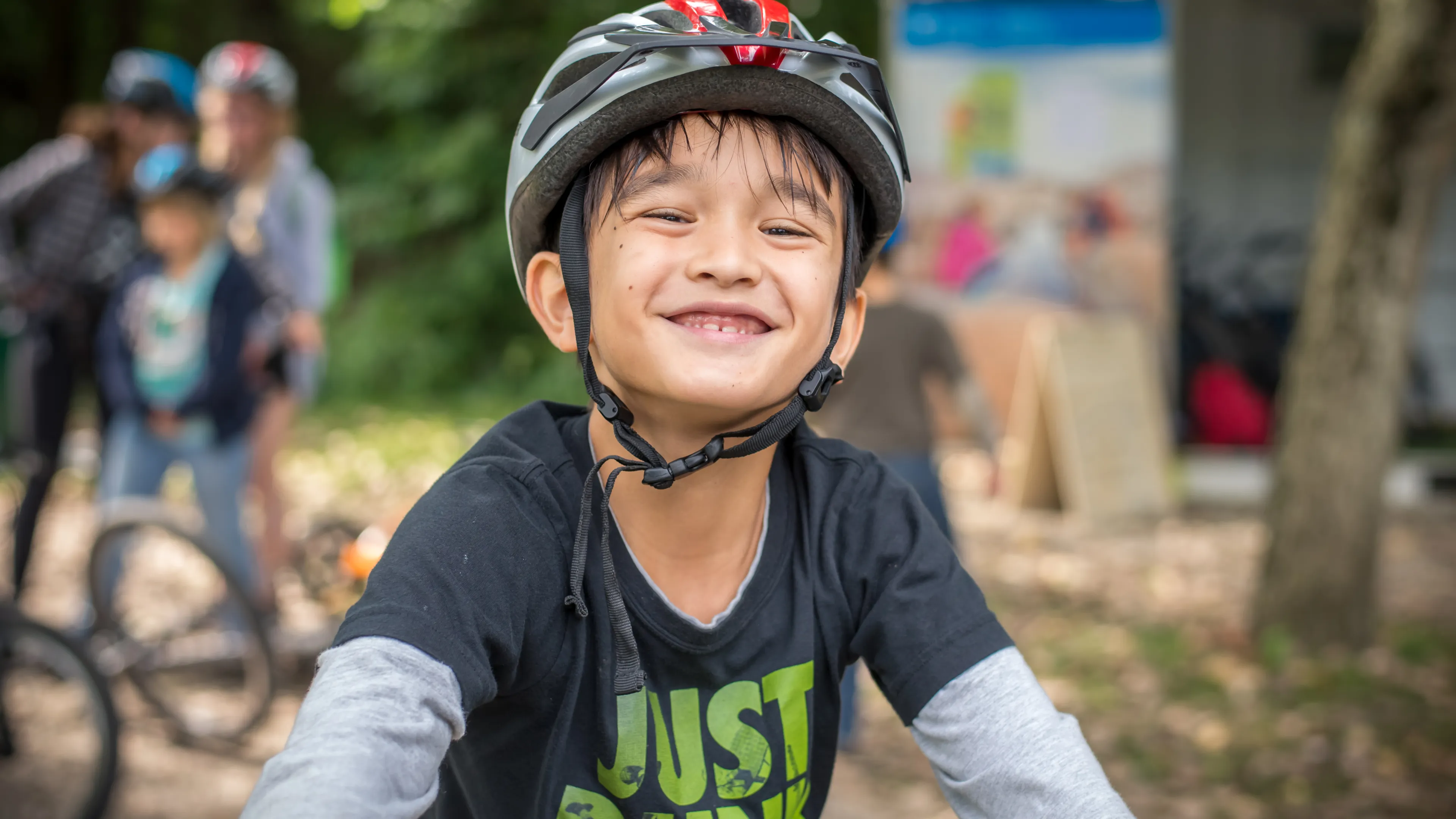 Smiling boy getting ready to ride his bike at Camp Henry