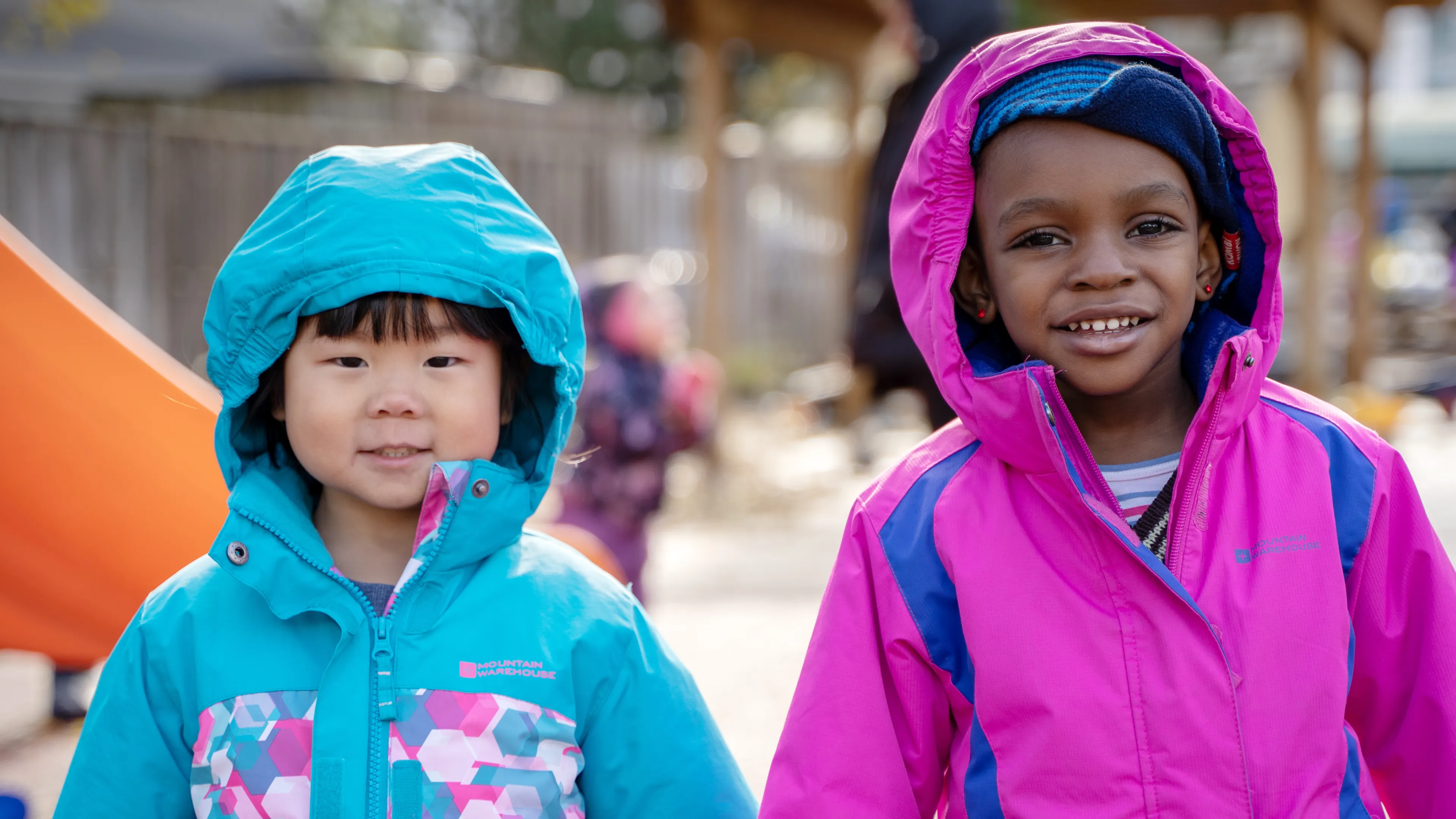 Two smiling girls playing outside
