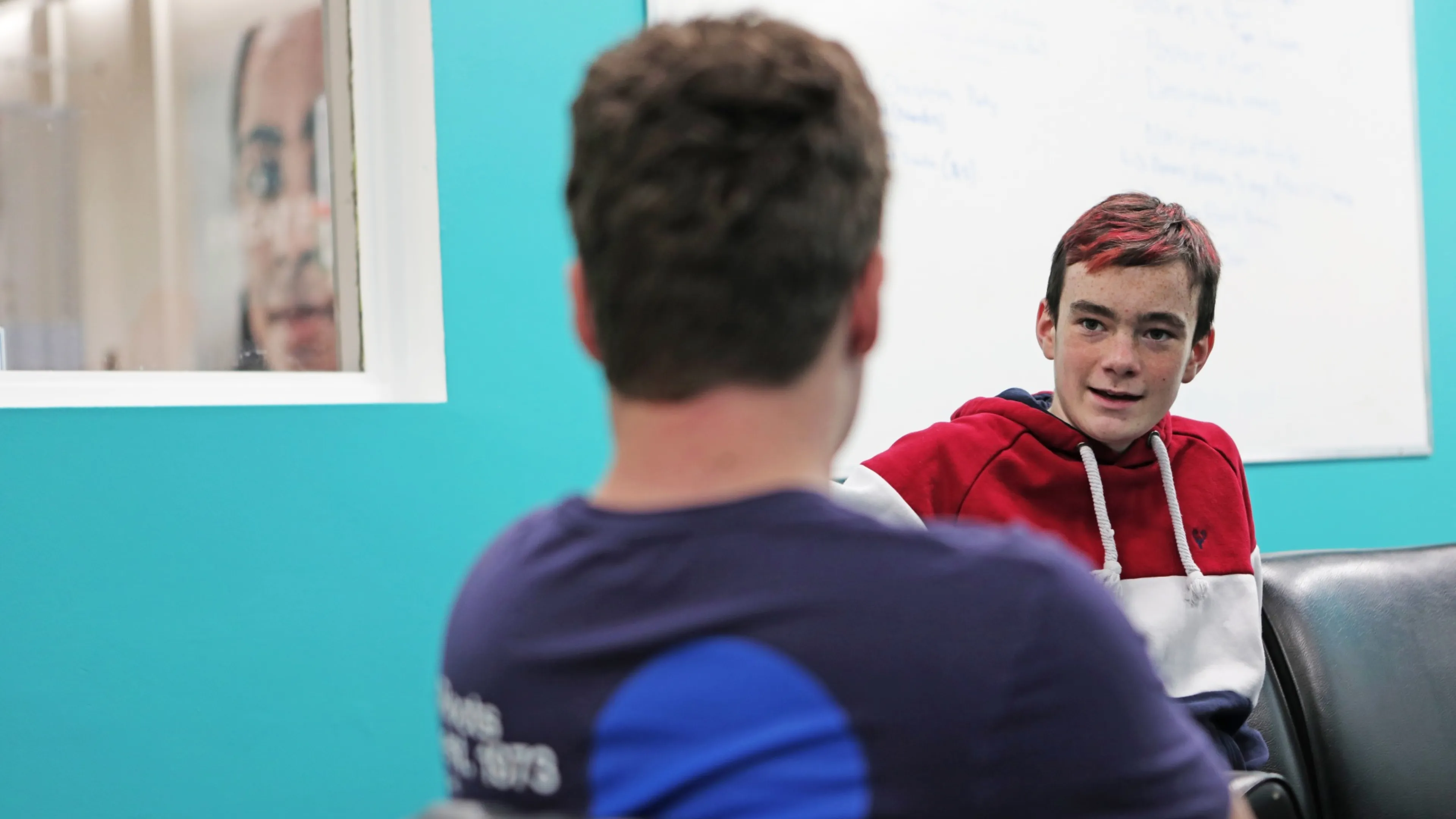 Youth sitting with adult