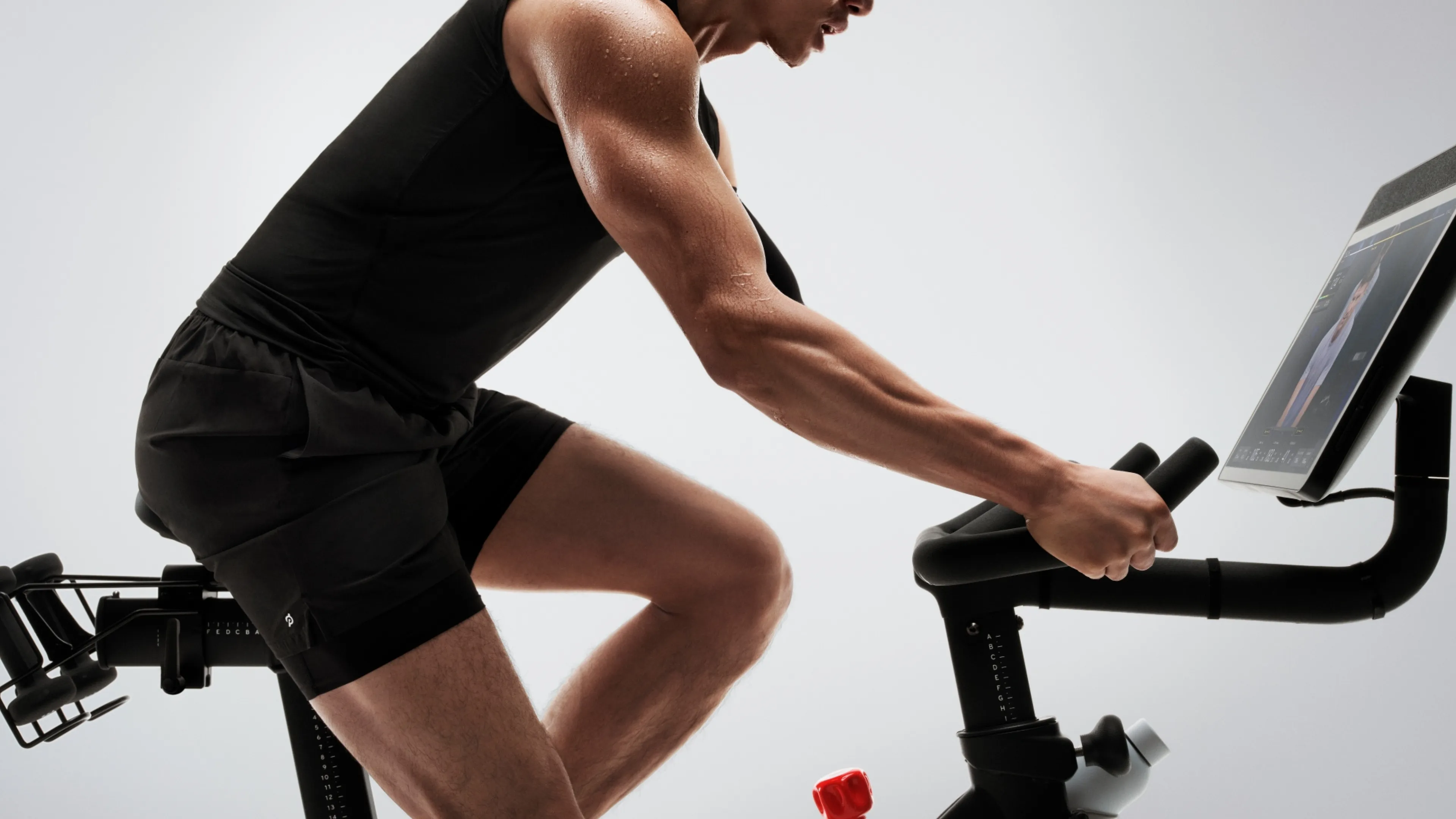 Man riding a Peloton bike