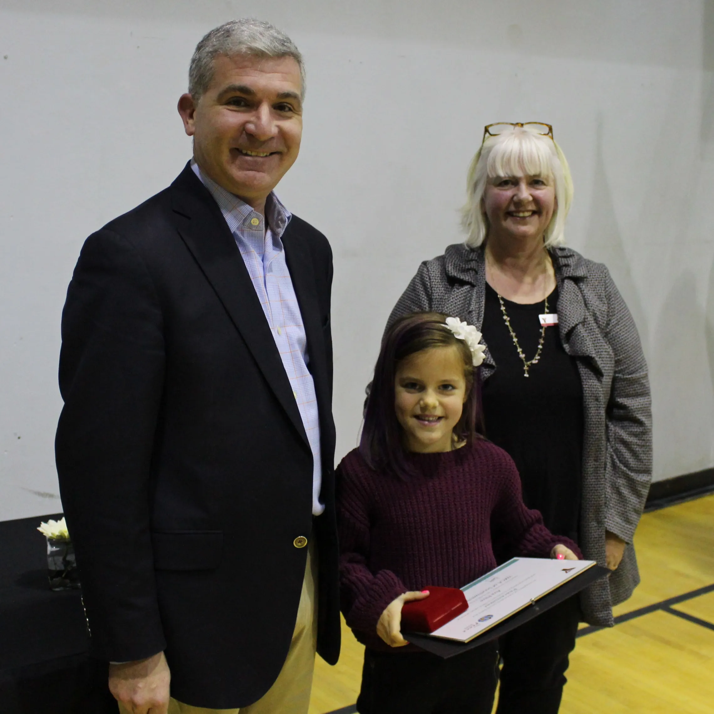 Ava stands next to YMCA CEO Andrew Lockie.