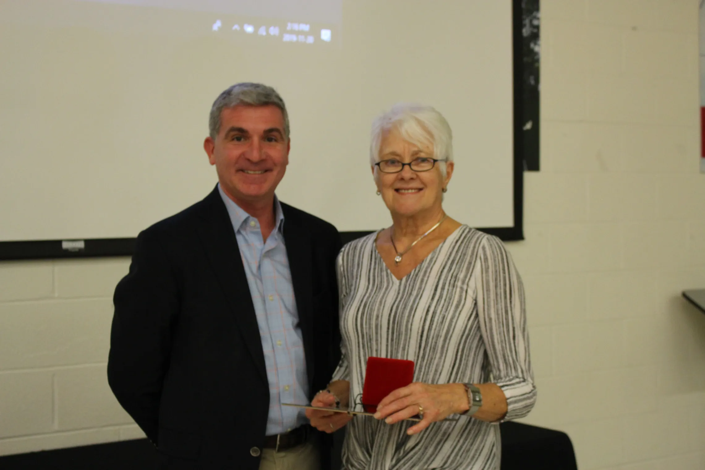 Henny stands with CEO Andrew Lockie.