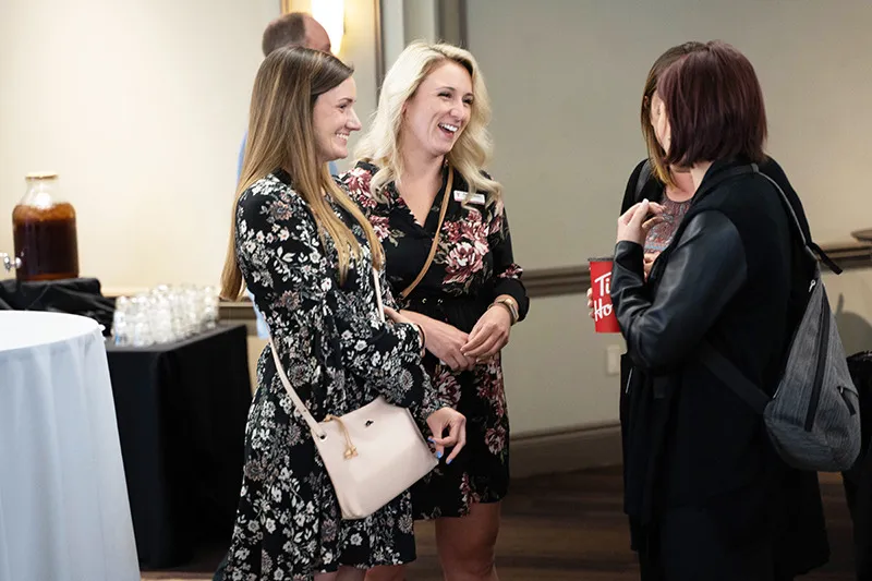 A group of staff members socialize at the event.