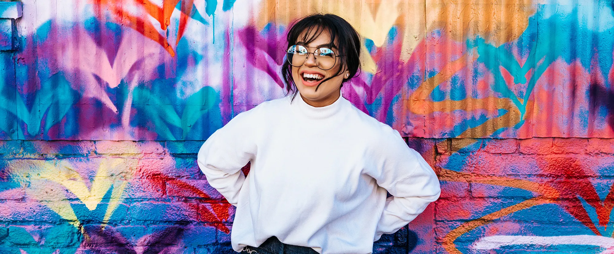 Teen in front of colourful wall