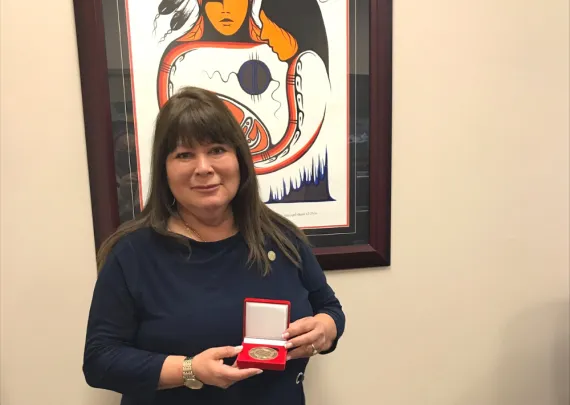 Jan Martin, Director Indigenous Relations, accepts the YMCA Peace Medal on behalf of the Southwest Ontario Aboriginal Health Access Centre.