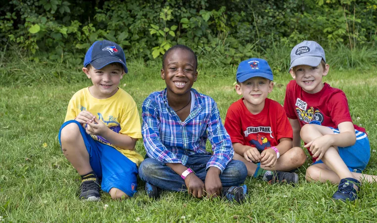 Boys sitting on the lawn during Summer Camp