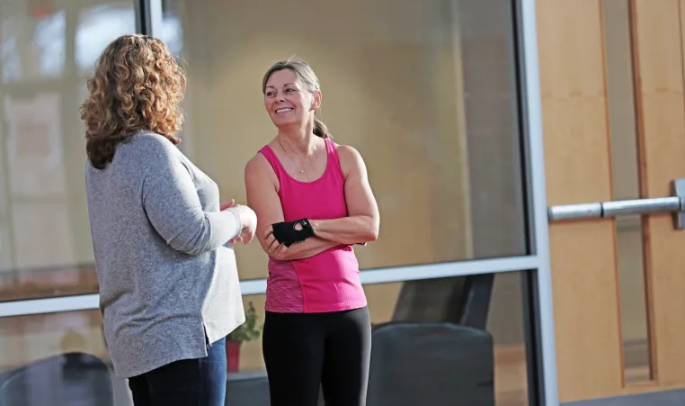 Two Y members chat in a branch common area.