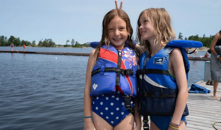 Two campers by lake having fun