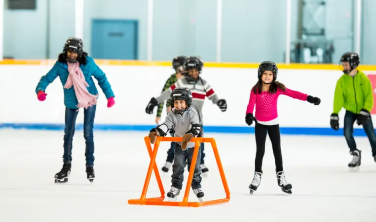 A newcomer family learns to skate in an arena.