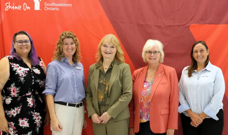 Five women infront of Y banner
