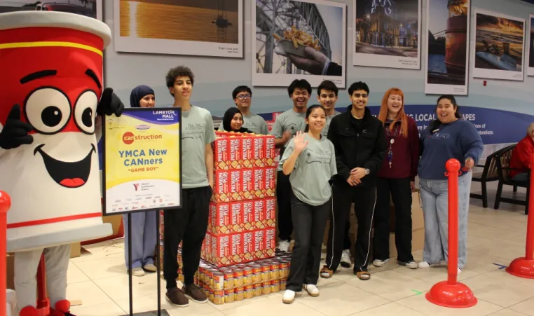 Young adults in front of Game Boy construction