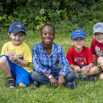 Boys sitting on the lawn during Summer Camp