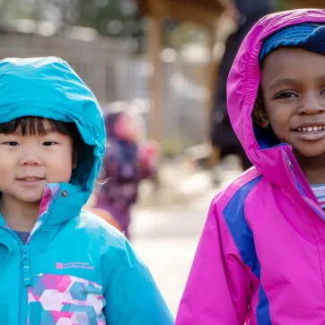 Two smiling girls playing outside 