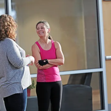 Two Y members chat in a branch common area.