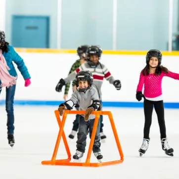 A newcomer family learns to skate in an arena.