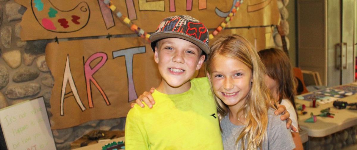 Campers showing off art work at Camp Henry