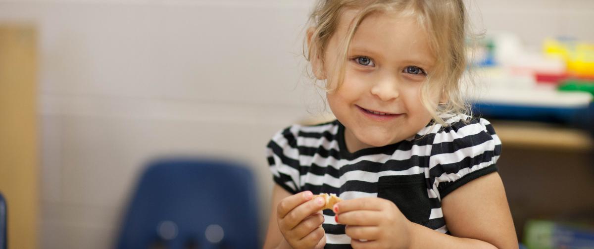 Girl having a snack during after care
