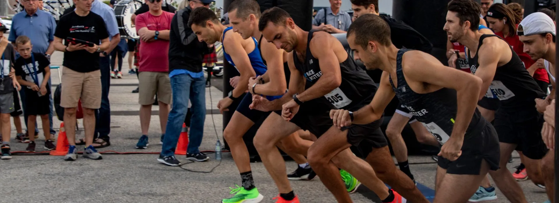 A group of men in colourful shoes get into starting position for Jordan's Run.