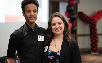 Two young staff members attend the YMCA's Annual Community Gathering.