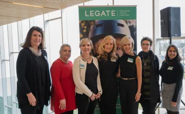 Seven of the 2019 Women of Excellence pose at a media event.