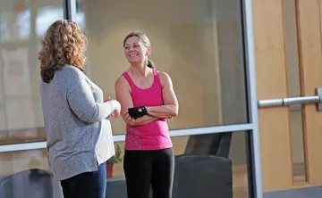 Two Y members chat in a branch common area.