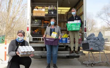 London Food Bank Co-Executive Director Jane Roy, South London Neighbourhood Resource Centre Executive Director Nancy Needham (centre), and YMCA Southwestern Ontario CEO Andrew Lockie outside the food bank's mobile food truck.