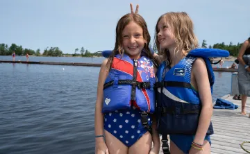 Two campers by lake having fun