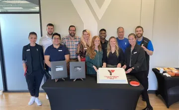 People celebrating around a cake