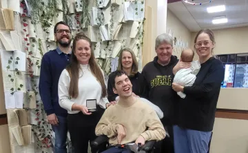 Rachel Guerin - 2025 Peace Week Recipient standing with group of smiling people